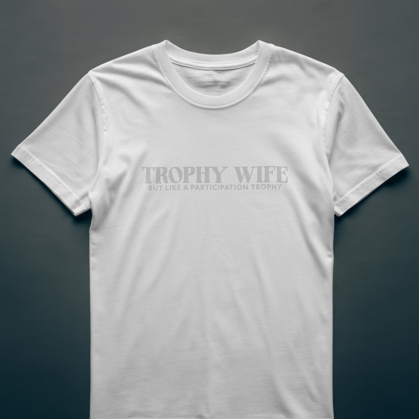 White t-shirt with Trophy Wife on a dark gray background
